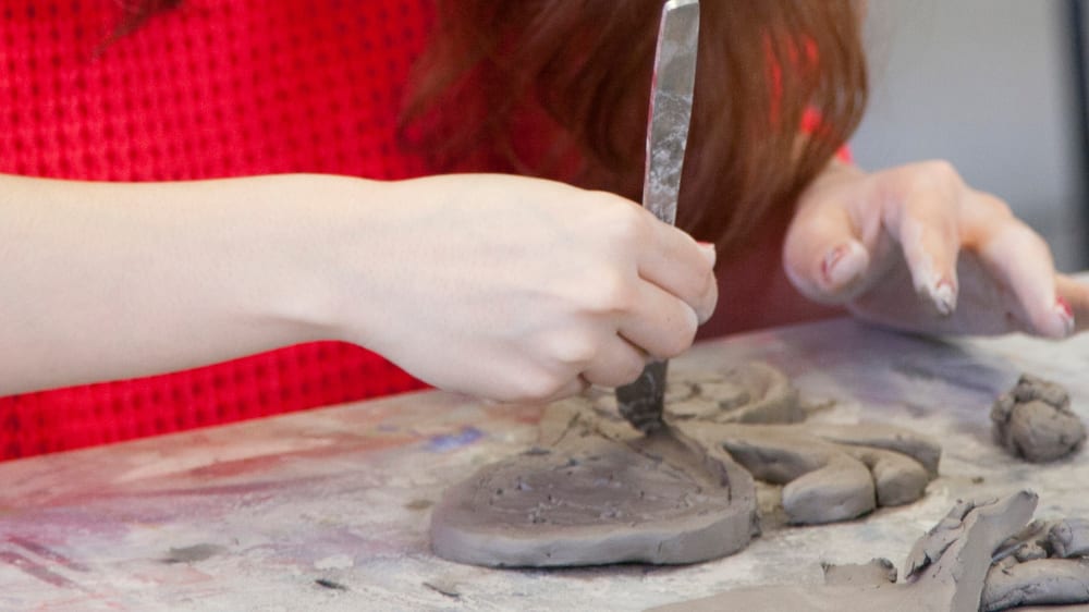Student working on a ceramic model