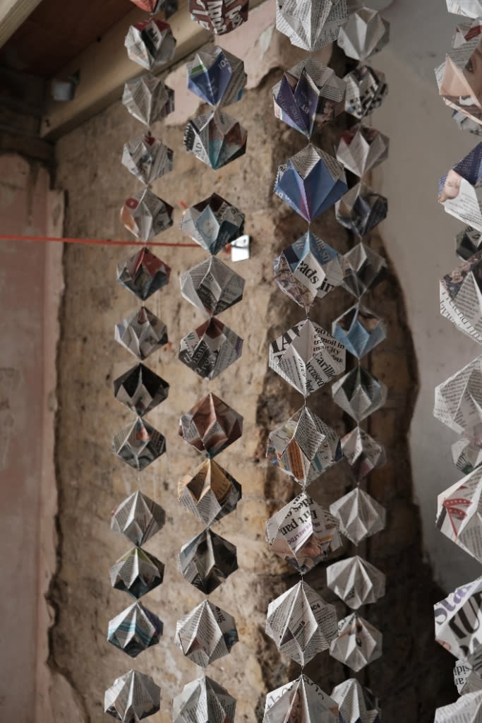 A string of paper objects hanging from the ceiling