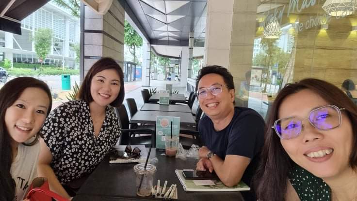 Four people smiling at the camera. 