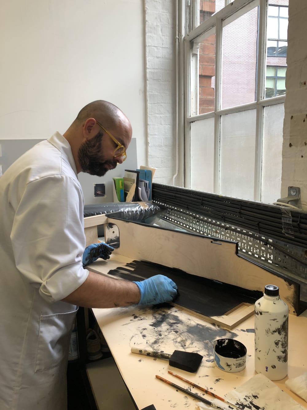 Person making footwear in workshop