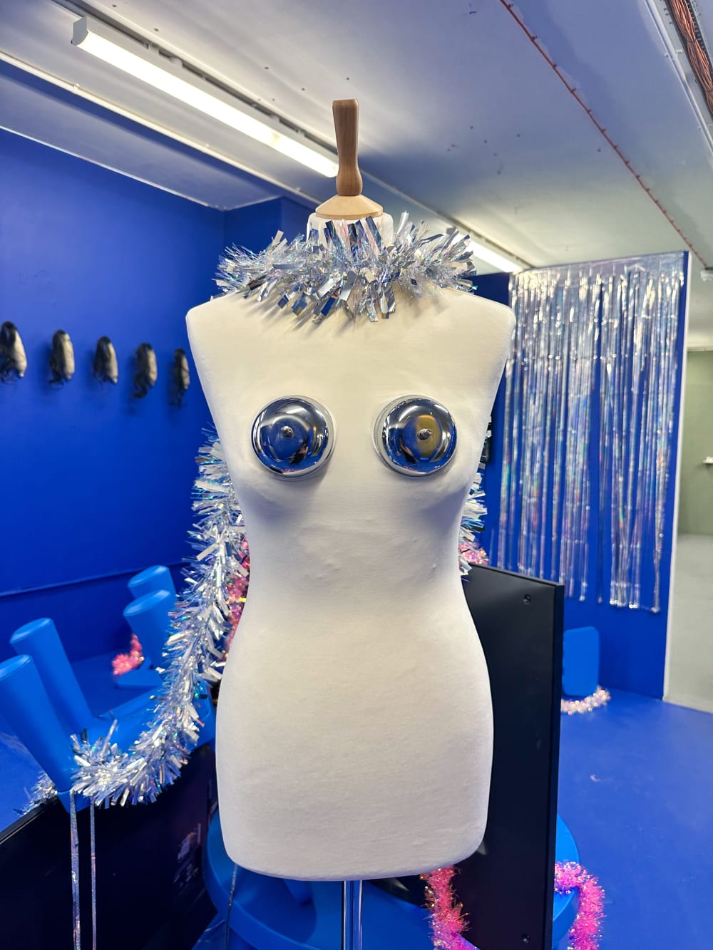 a mannequin with tinsel as a scarf