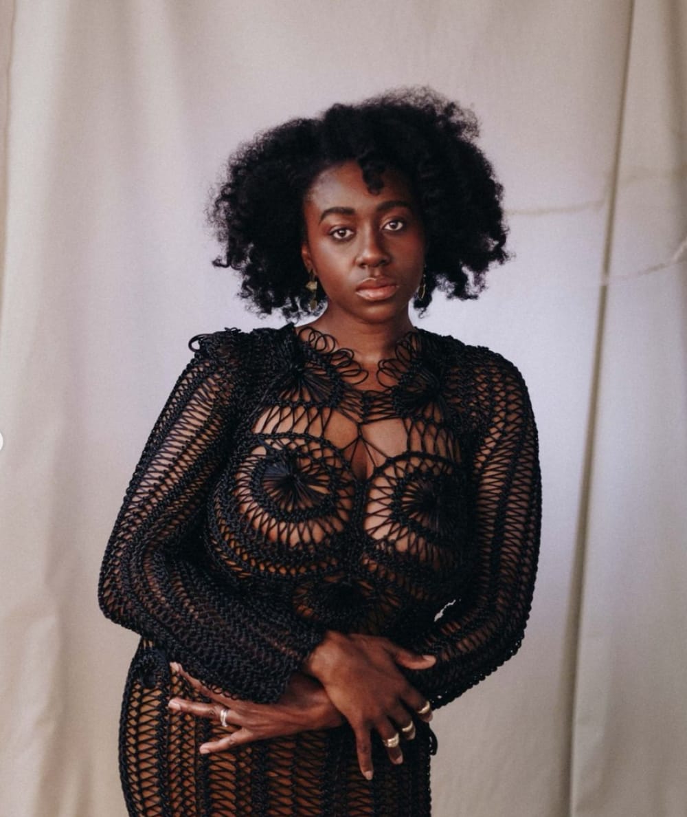 A woman wearing knitwear posing for the camera.