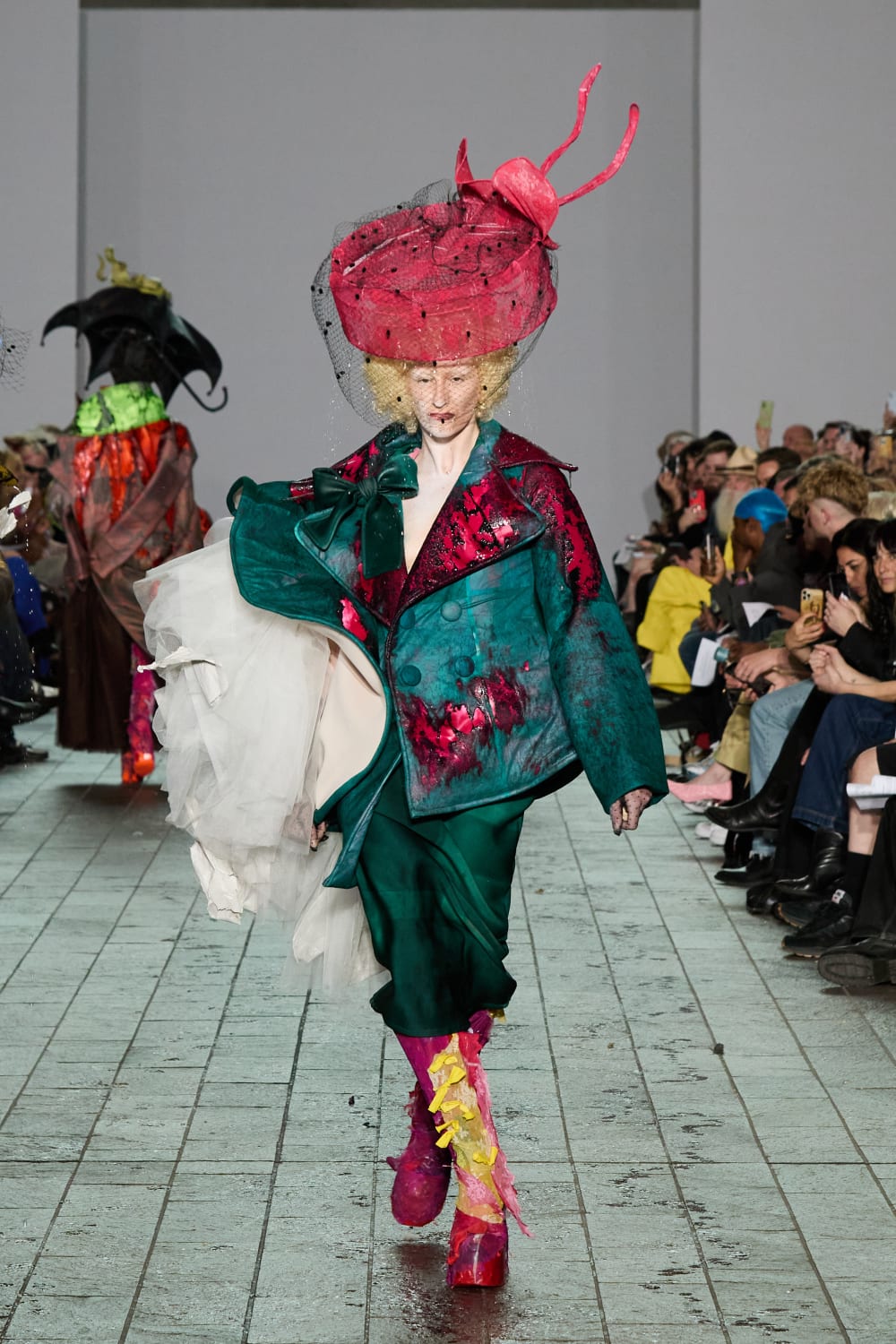 Model wears a large,flamboyant hat