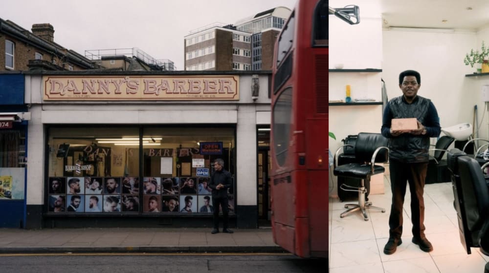 A barbers storefront with an image of a barber in his shop. 