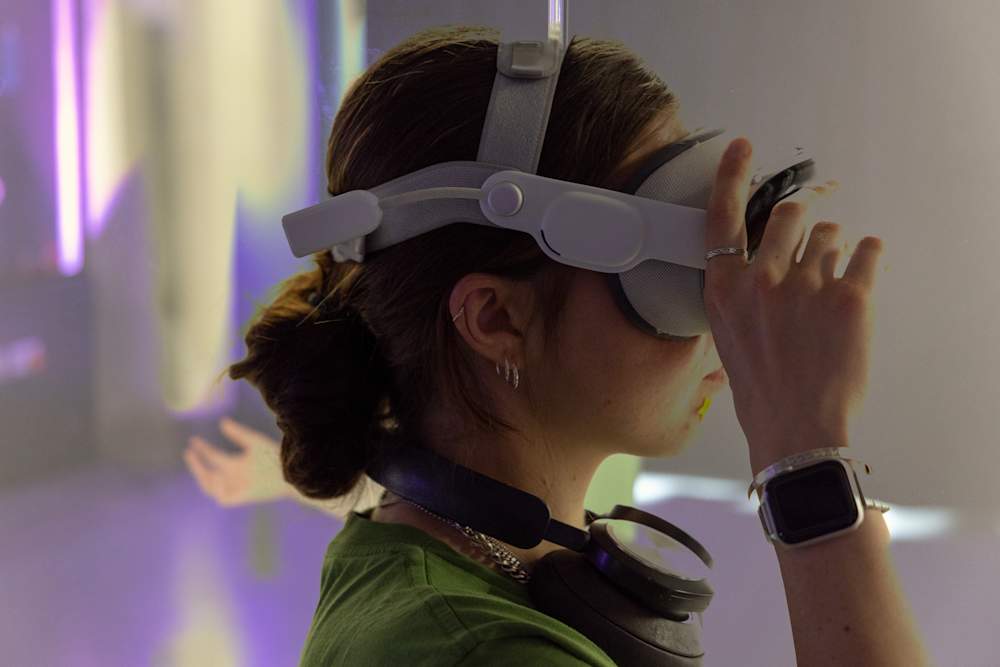 CCI Student shown from her side profile is wearing an Apple Vision Pro gadget