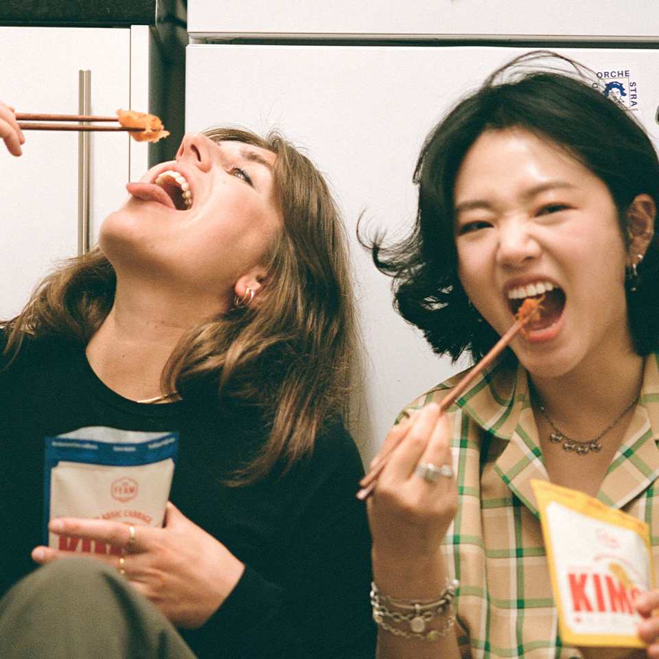 Rebecca Ghim and Dr. Maylin Stantic, founder and business partner of The Ferm eat their kimchi from pouches with chopsticks