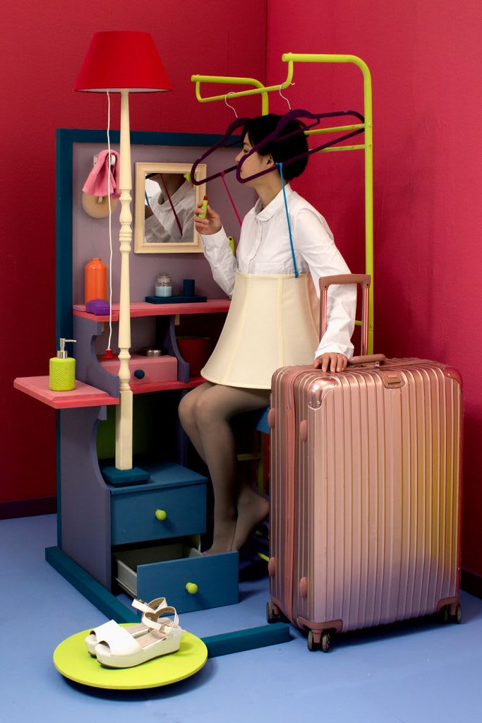 A model surrounded by colorful furniture.