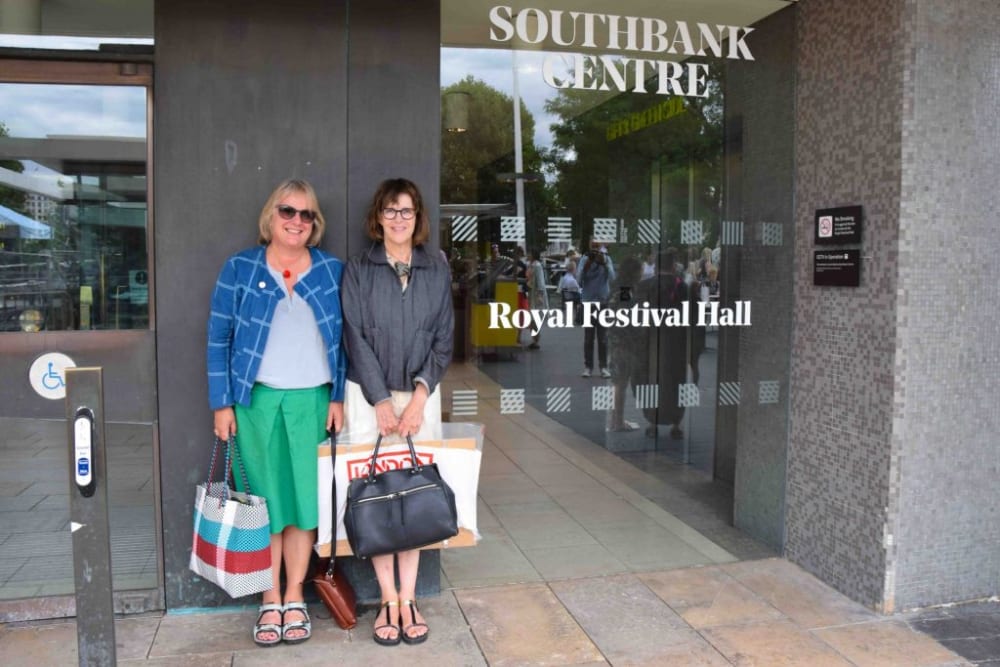 Two women standing outside of the Royal Festival Hall
