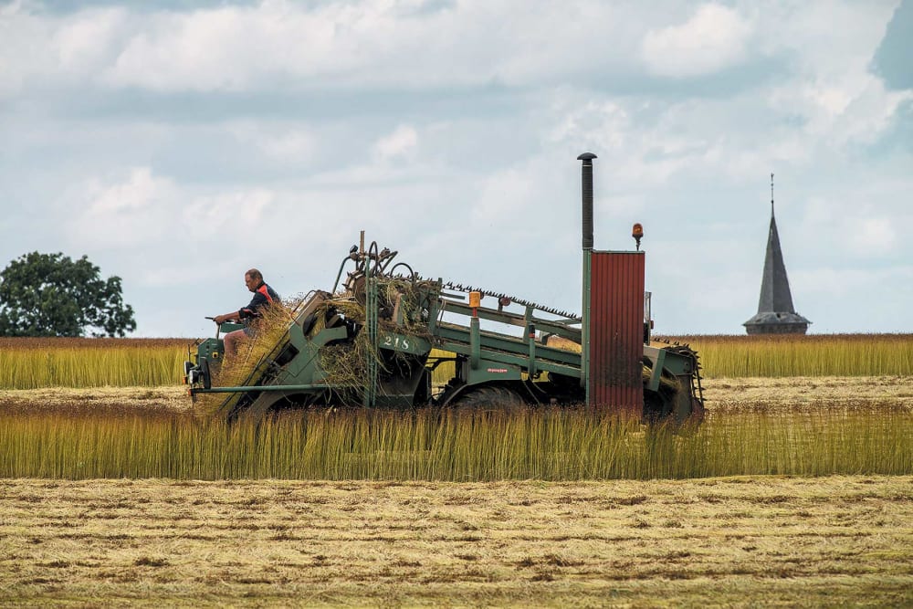 A man driving a tractor in a field