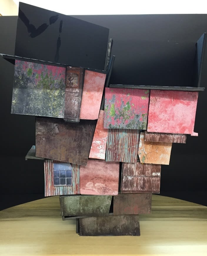 A collection of colorful stacked boxes creating a house.