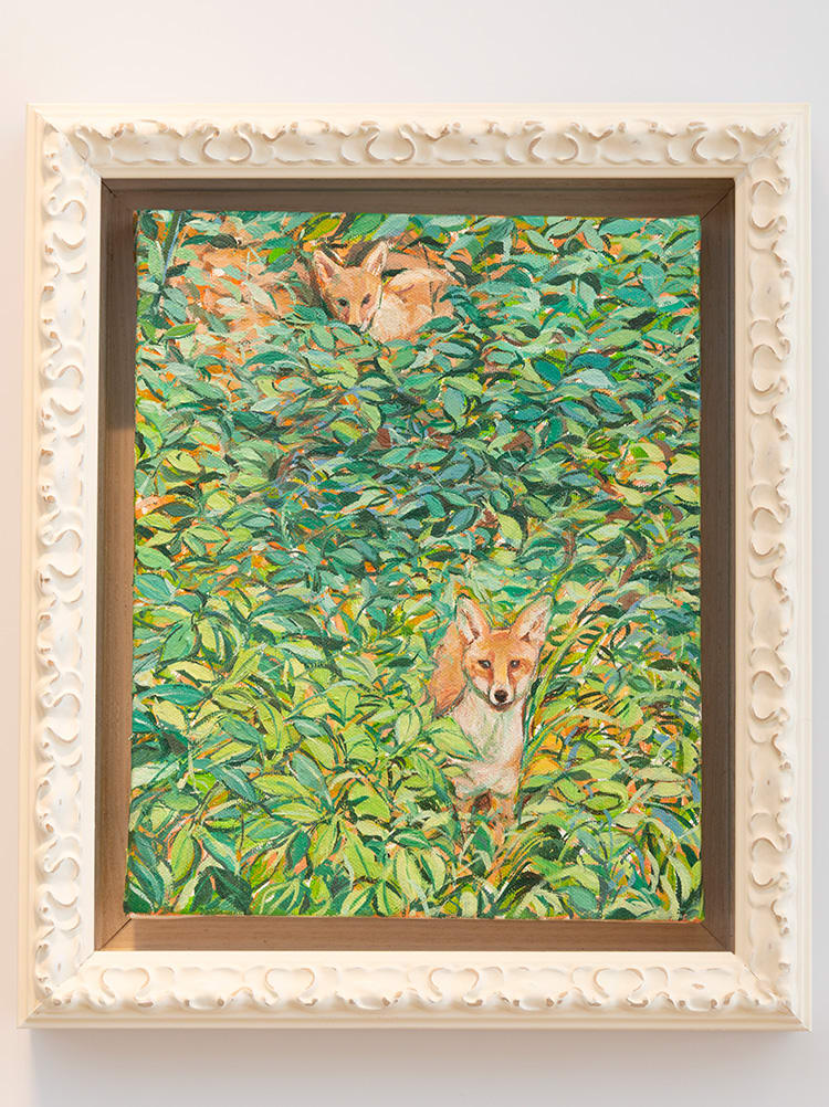 Framed oil painting of an overgrown garden with 2 foxes peering out