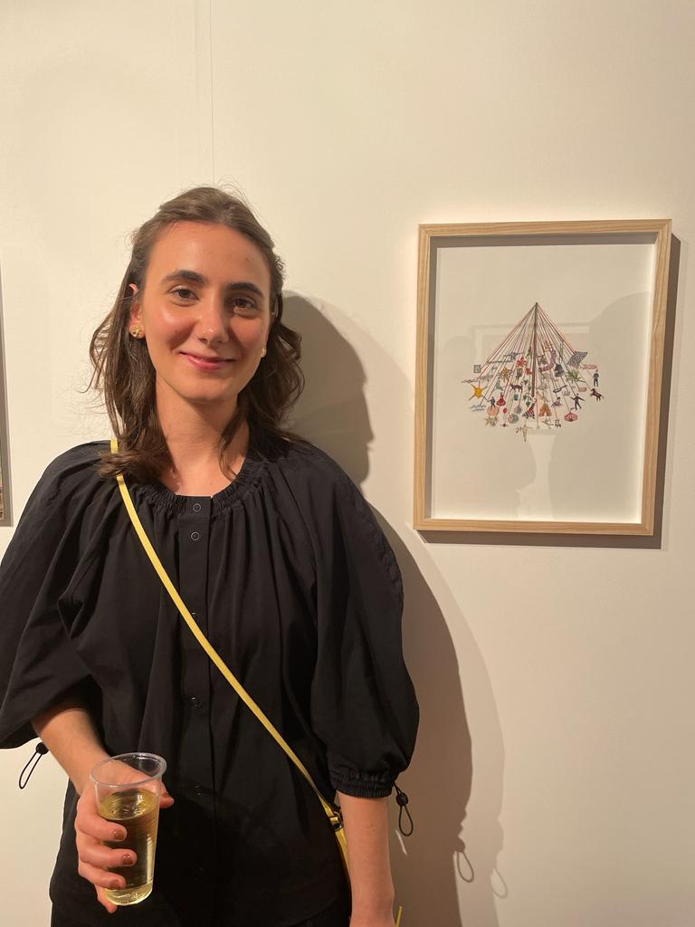 Artists in front of her artwork