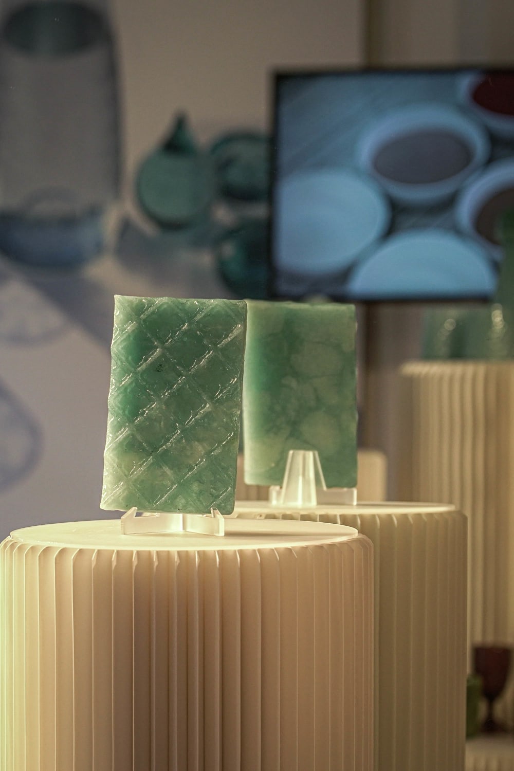 Sections of green glass sitting on plinths