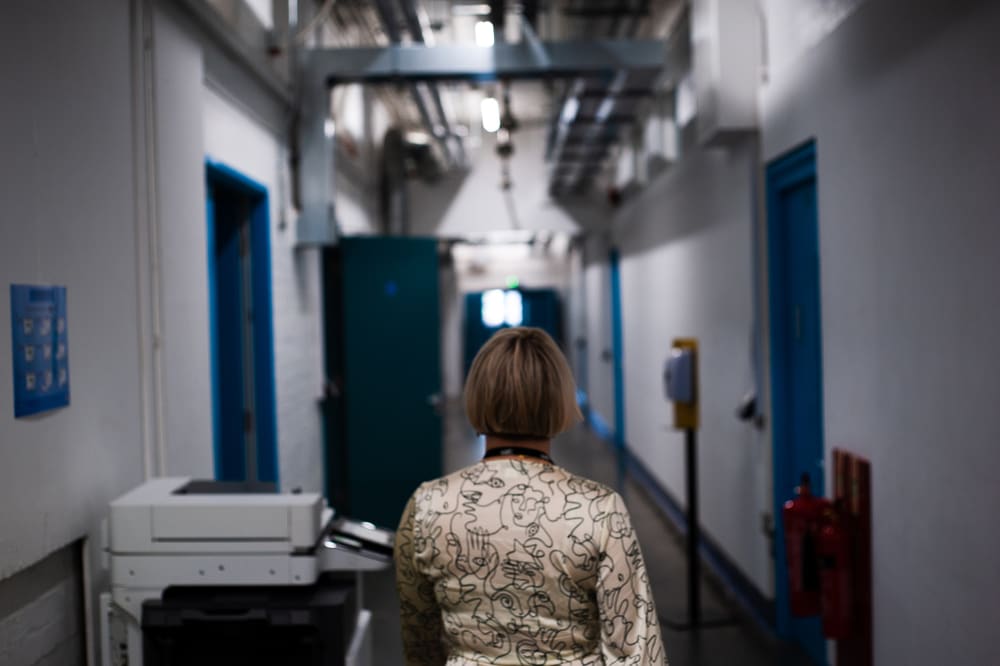 A person walks through a long corridor of a college