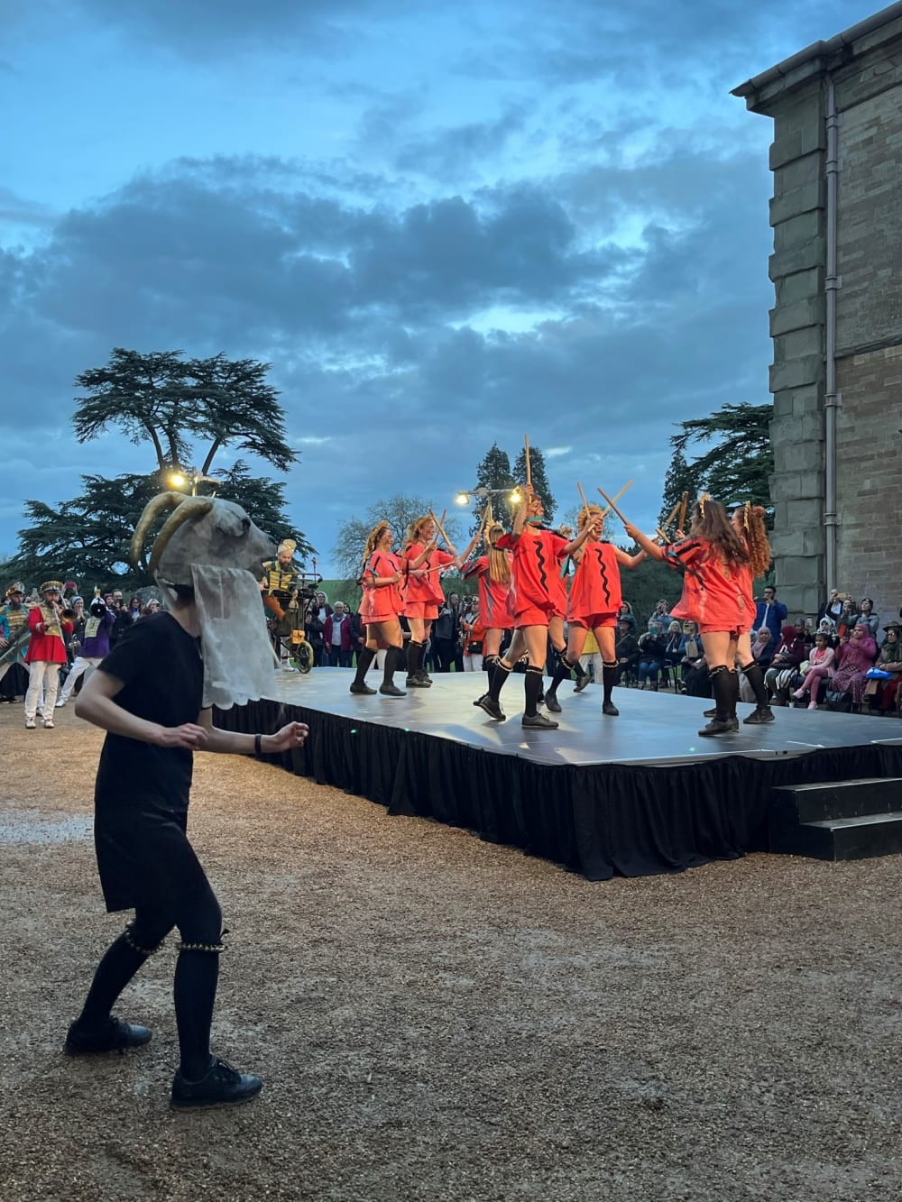 Boss Morris dancing on stage in orange morris gear