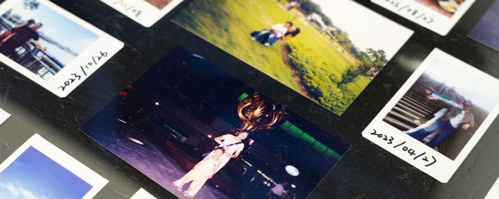 Photograph of polaroids laid out on a table.