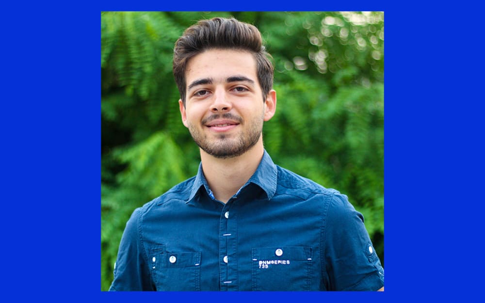 A person smiles at the camera.