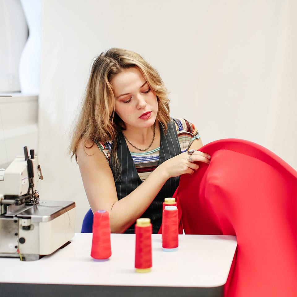 Student Flo Pawley constructs her red costume in the studio