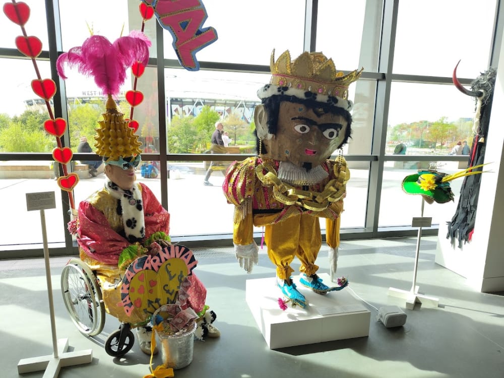 Hackney para carnival exhibit of large headed figure and wheelchair