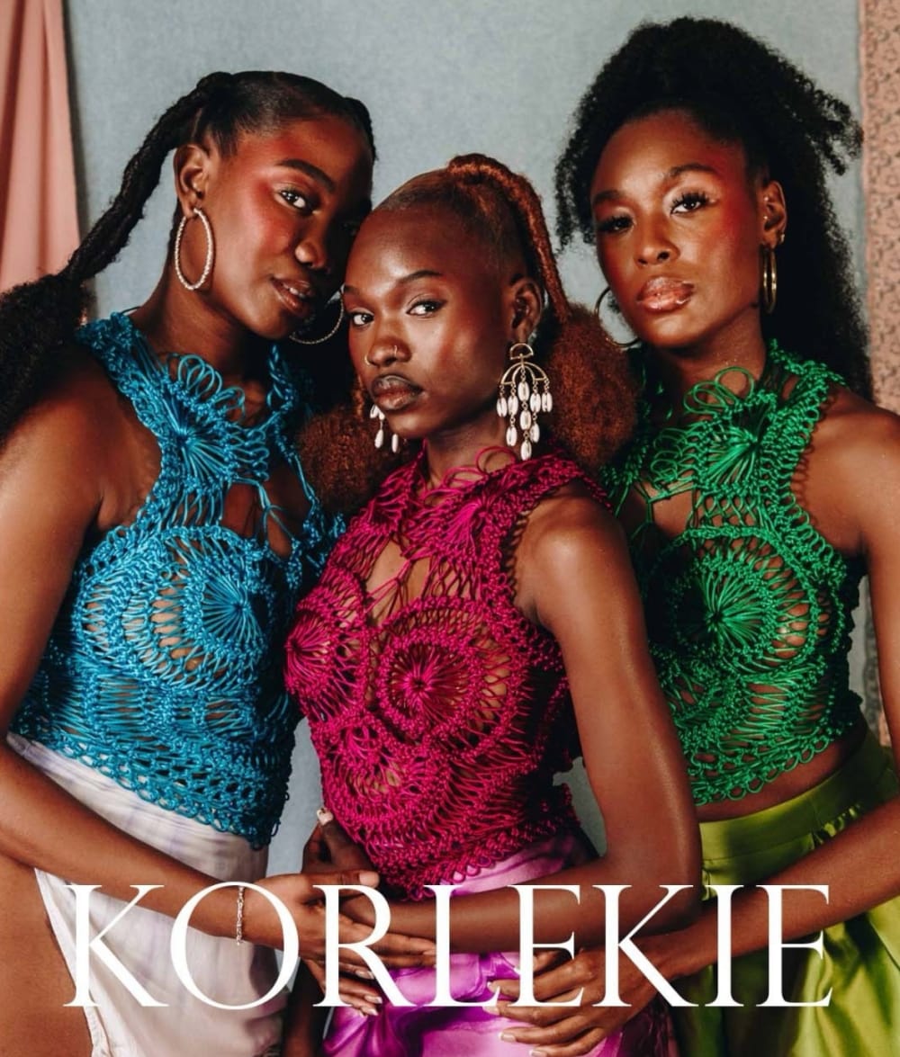 Three women wearing knitwear tops.