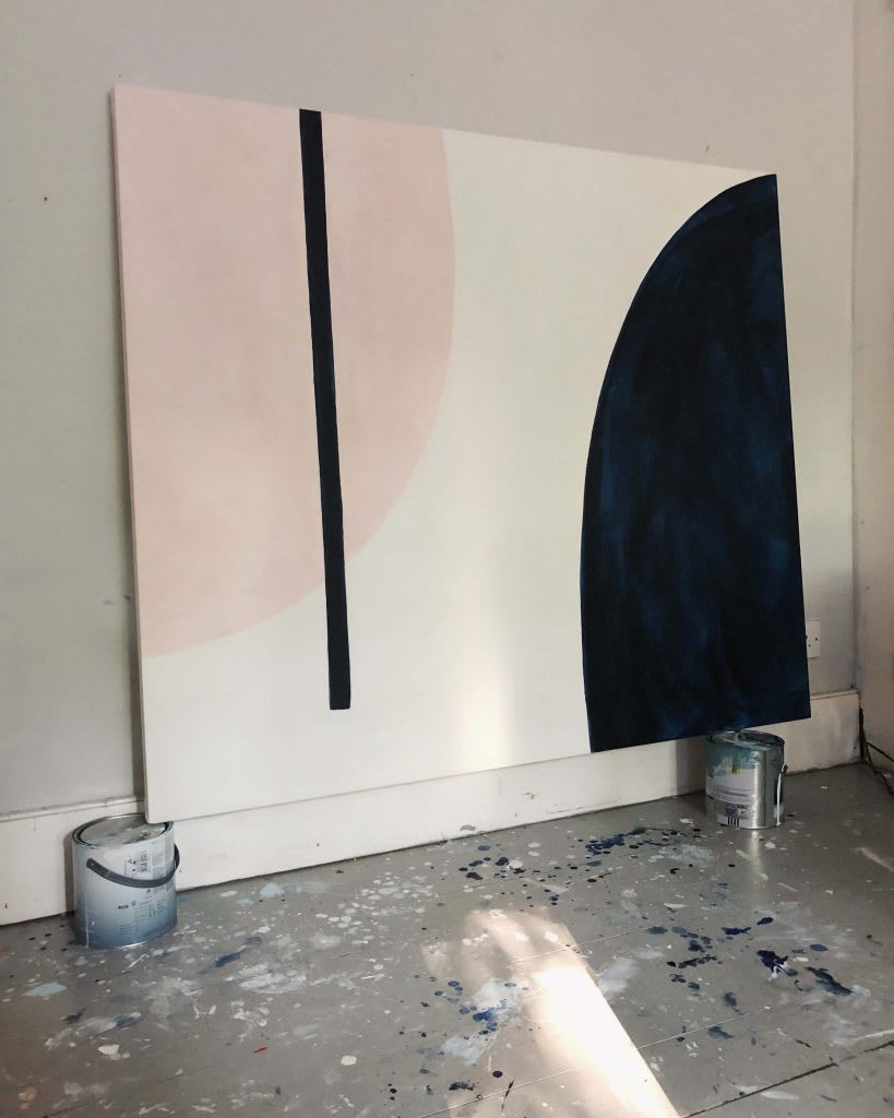 A large abstract white painting with a pink and black semi-circle and a black line.