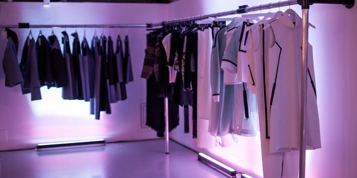Student fashion collections on display at an exhibition.