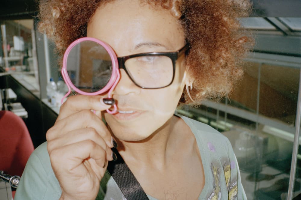 a person holds a mirror up to their eye