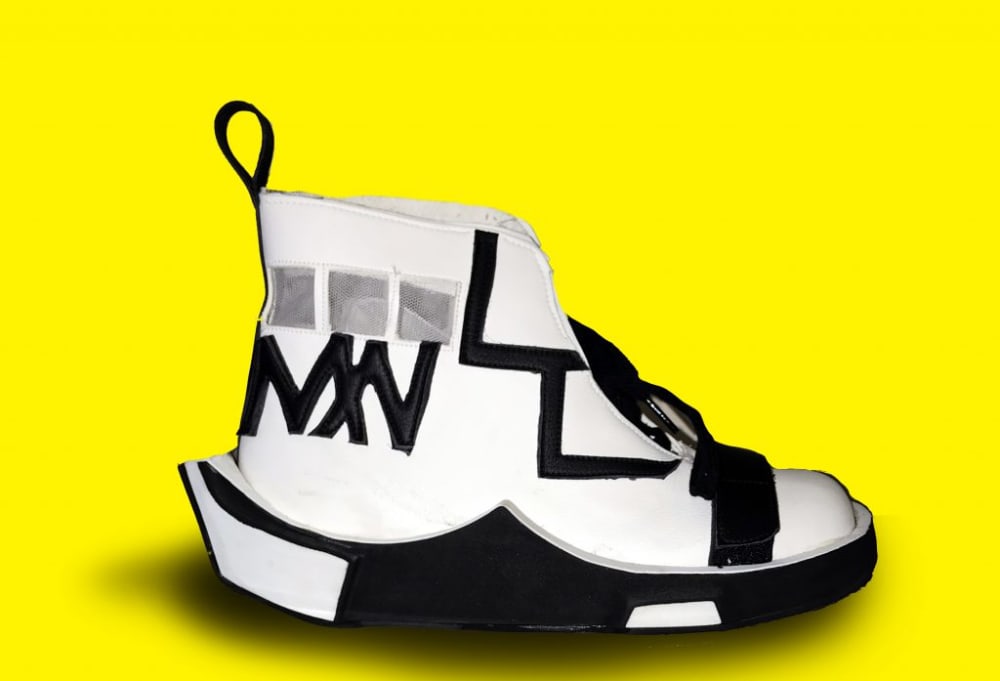 a studio shot of a white and black sneaker in front of a yellow background