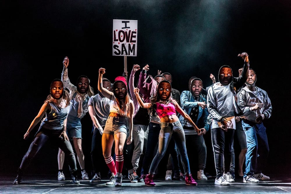a group of dancers on a spotlit stage