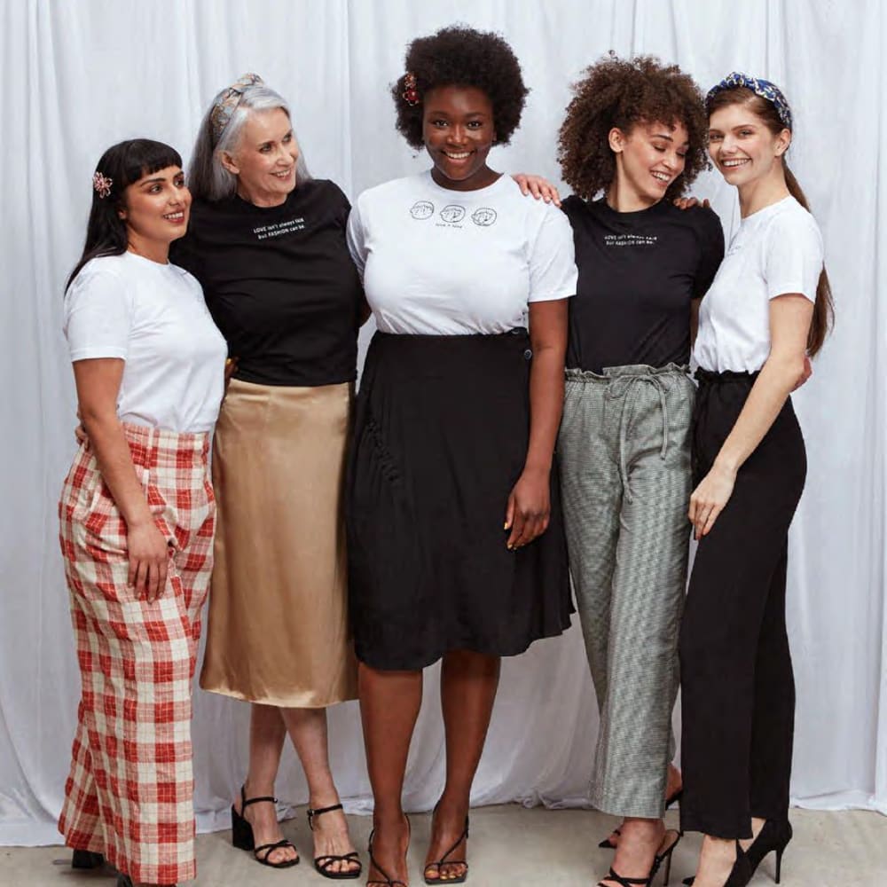 Five women stood together smiling
