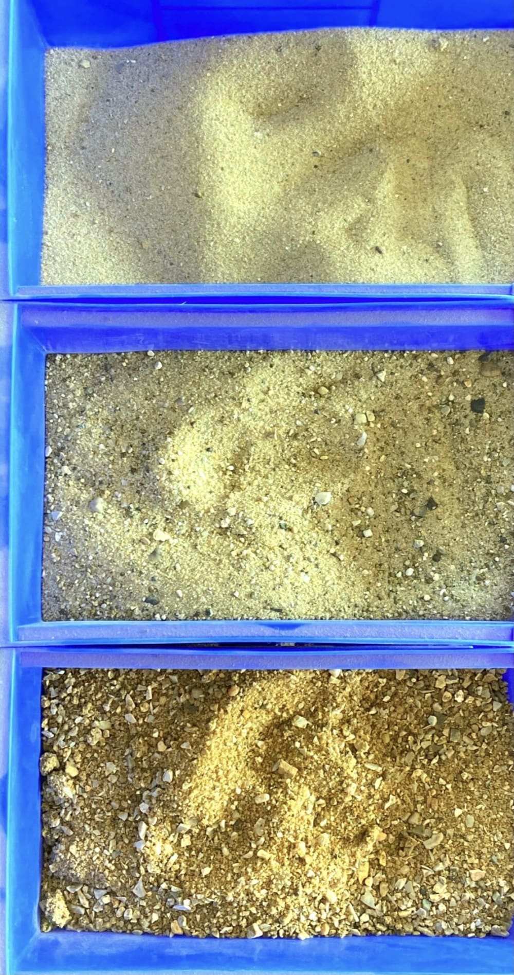 three containers of different types of sand