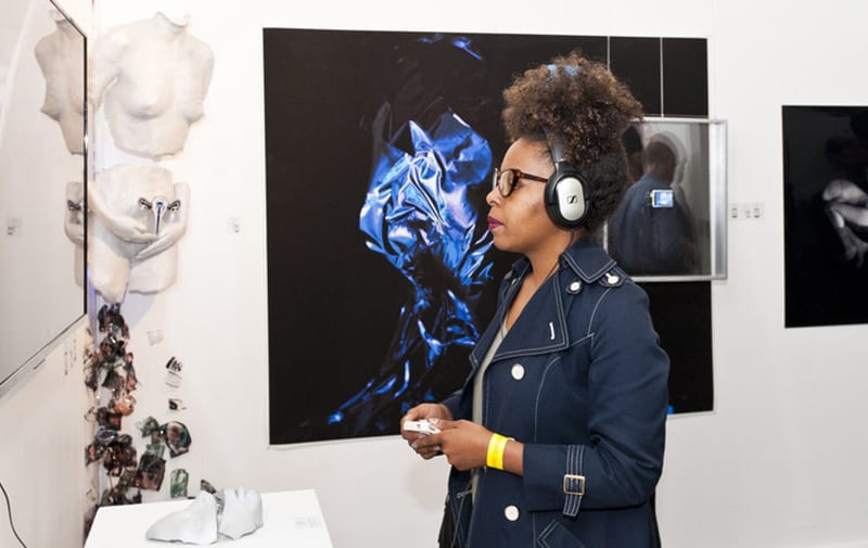 Girl wearing headphones at a private view event