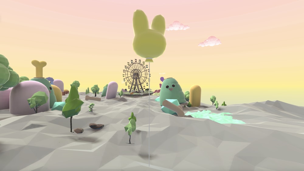 A digitised landscape of grey sand against a yellow/orange sky, there are oversized plush toys and fairground rides.