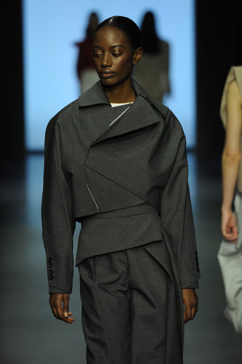 Person modelling charcoal-grey suit