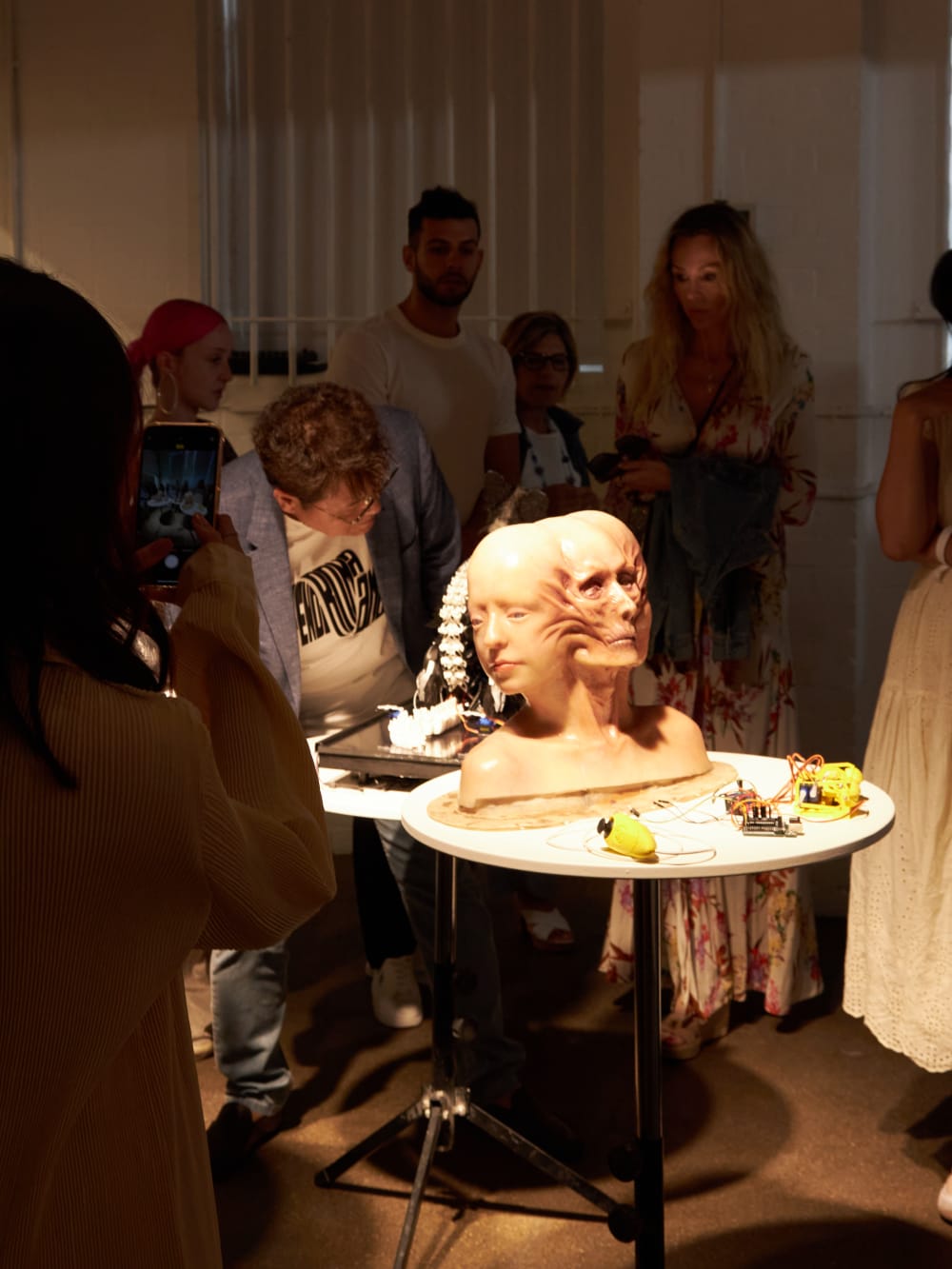 Morphed heads display with people looking at it