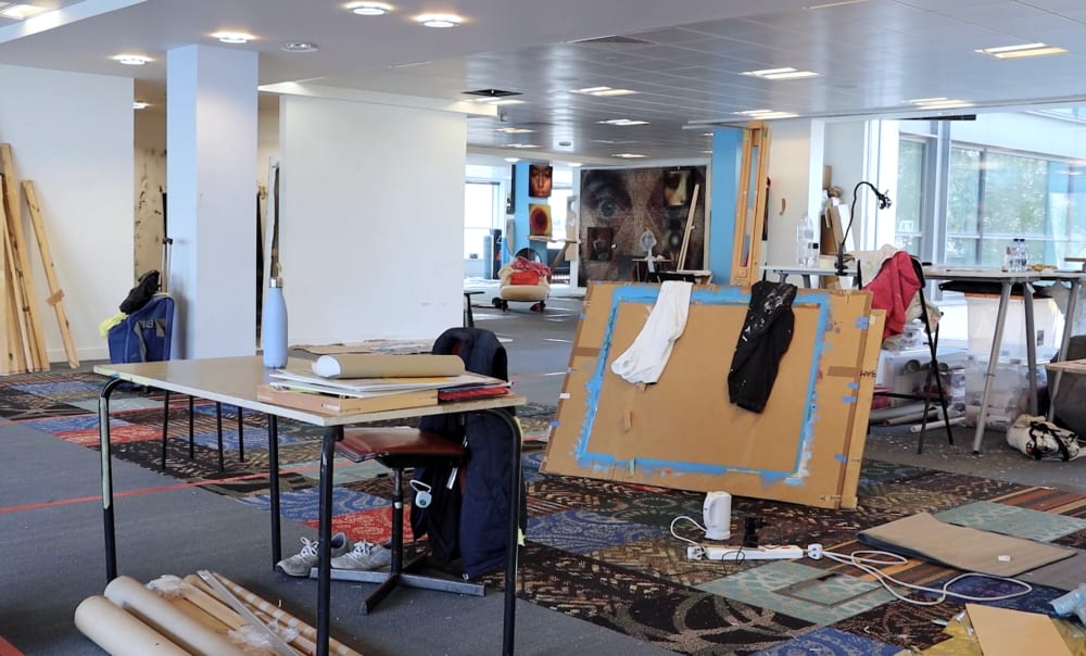 An open plan studio with lots of utensils for painting and art making