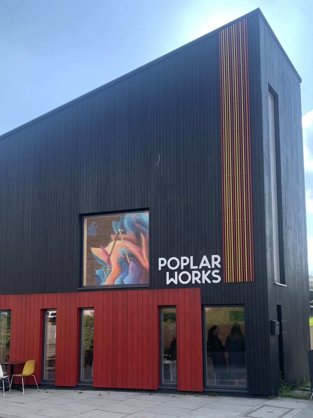 A photo of the black and red Poplar Works building