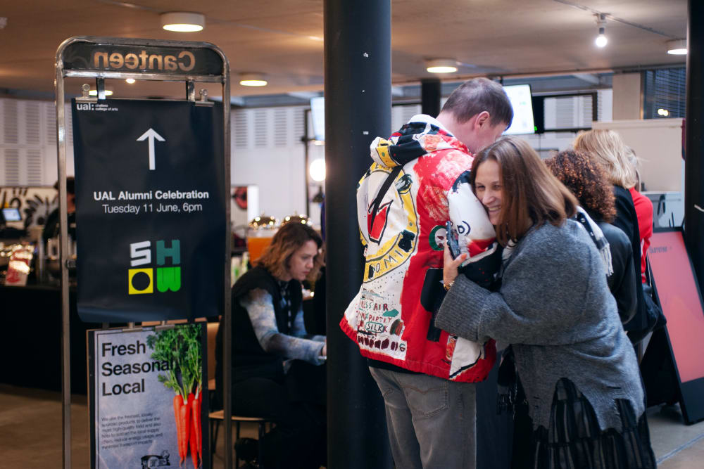 Guests hugging in the Chelsea canteen at the event. 