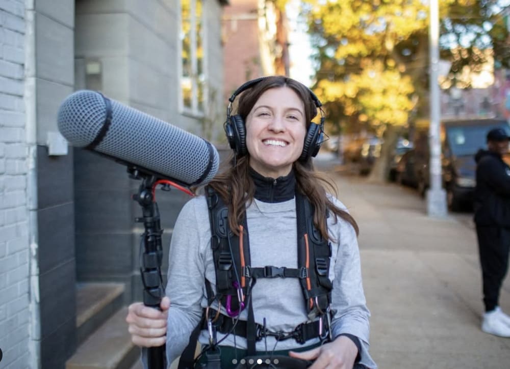 Woman on a film set wearing headphones and a microphone