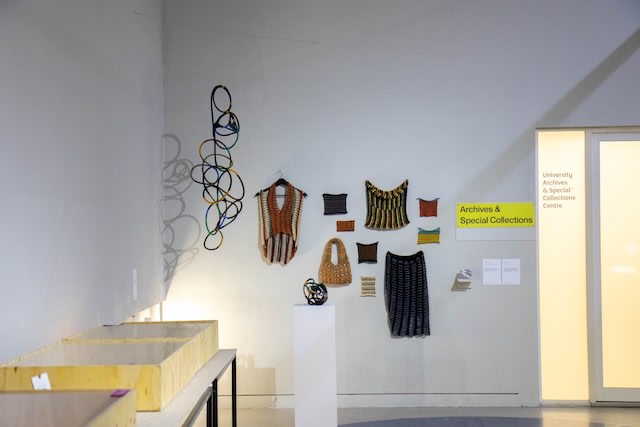 Items of clothes as artwork on white wall