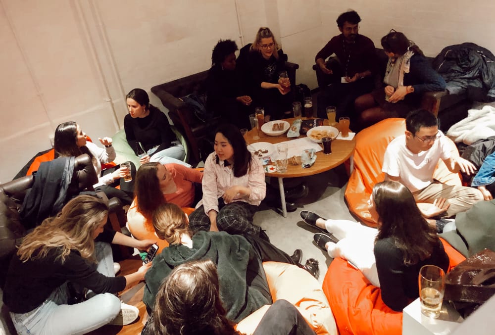 people chatting and drinking refreshments in the LCC Dark Room Bar