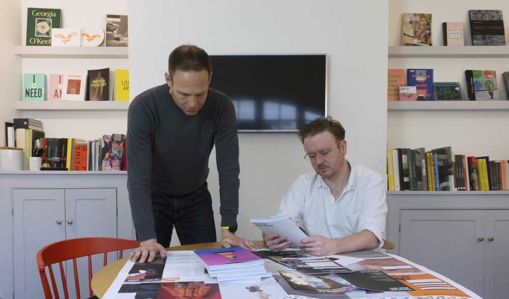 Geoff Williamson and Chis Curran look over designs in their London design studio