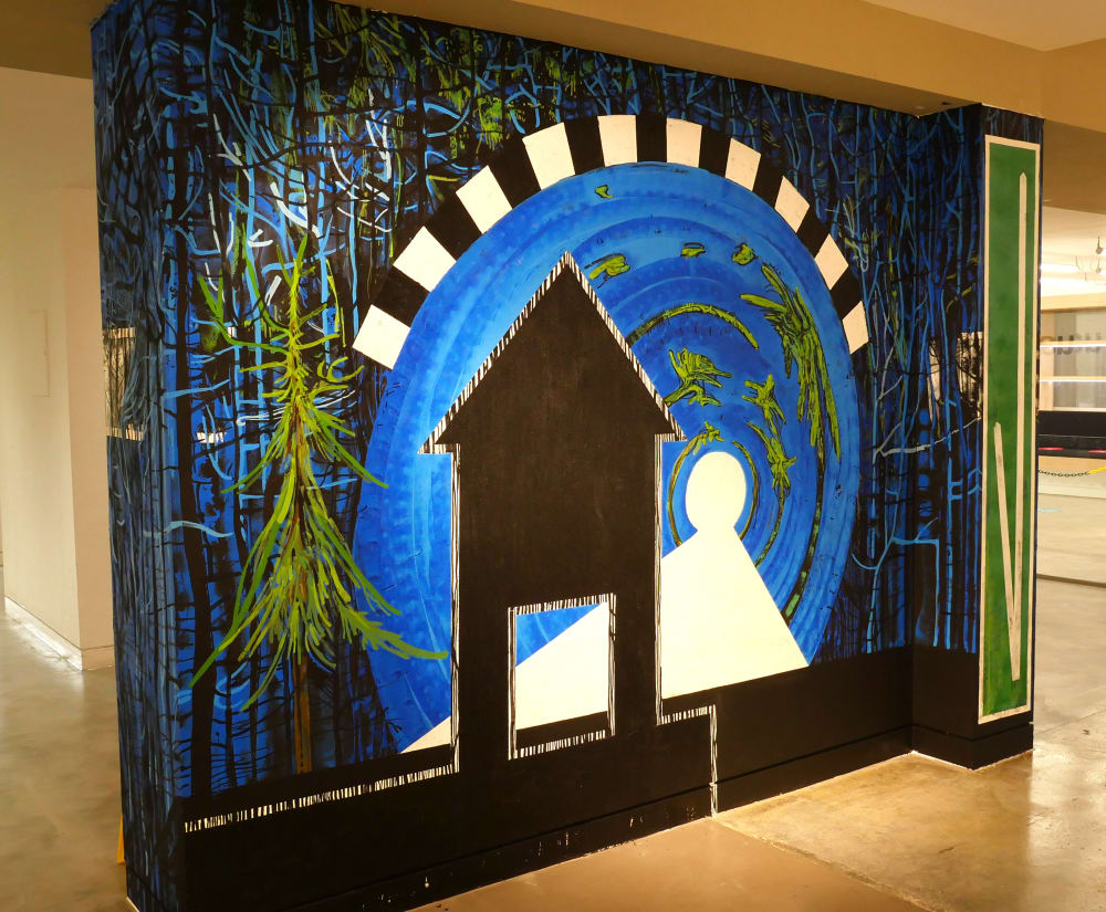 full view of one side of Sarah's wall mural. A forest scene surrounding road signs and markings. Blue,green and black colours.