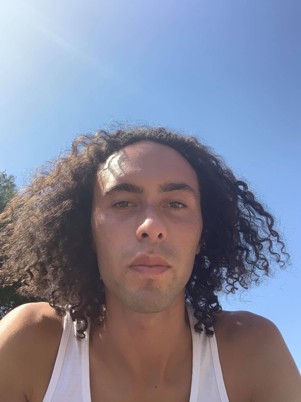 Harvey Dimond shot outdoors against a blue sky