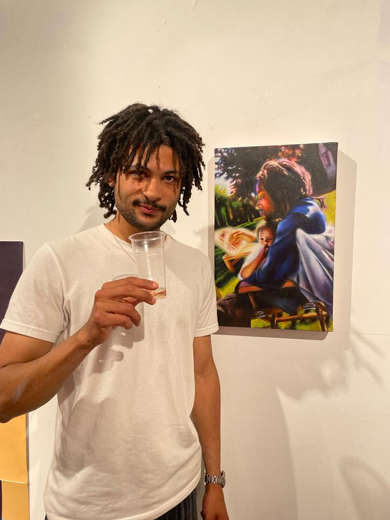 Artists in front of his artwork