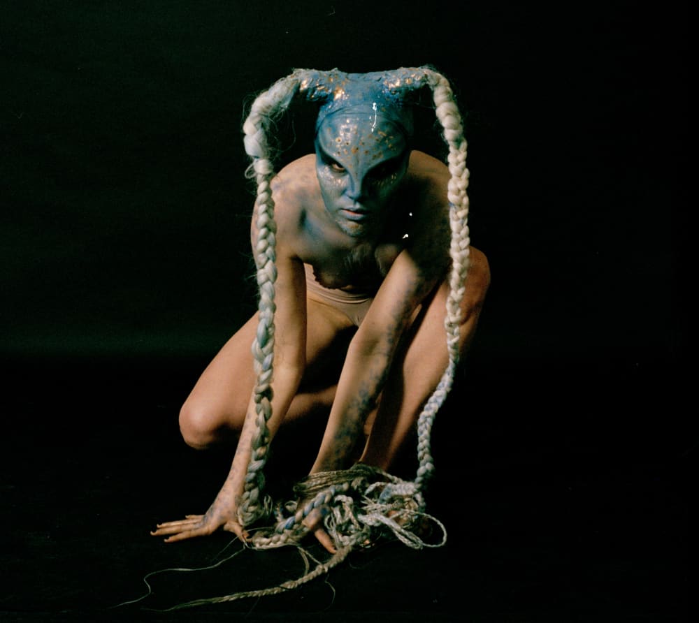 model in prosthetics and blue makeup