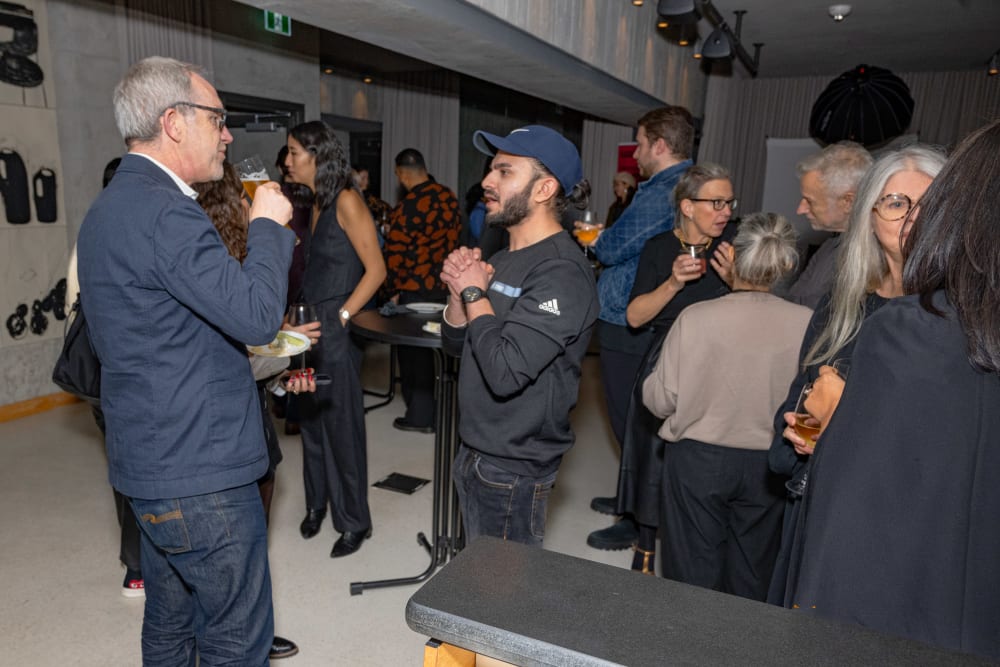 Guests at the reception talking in small groups.