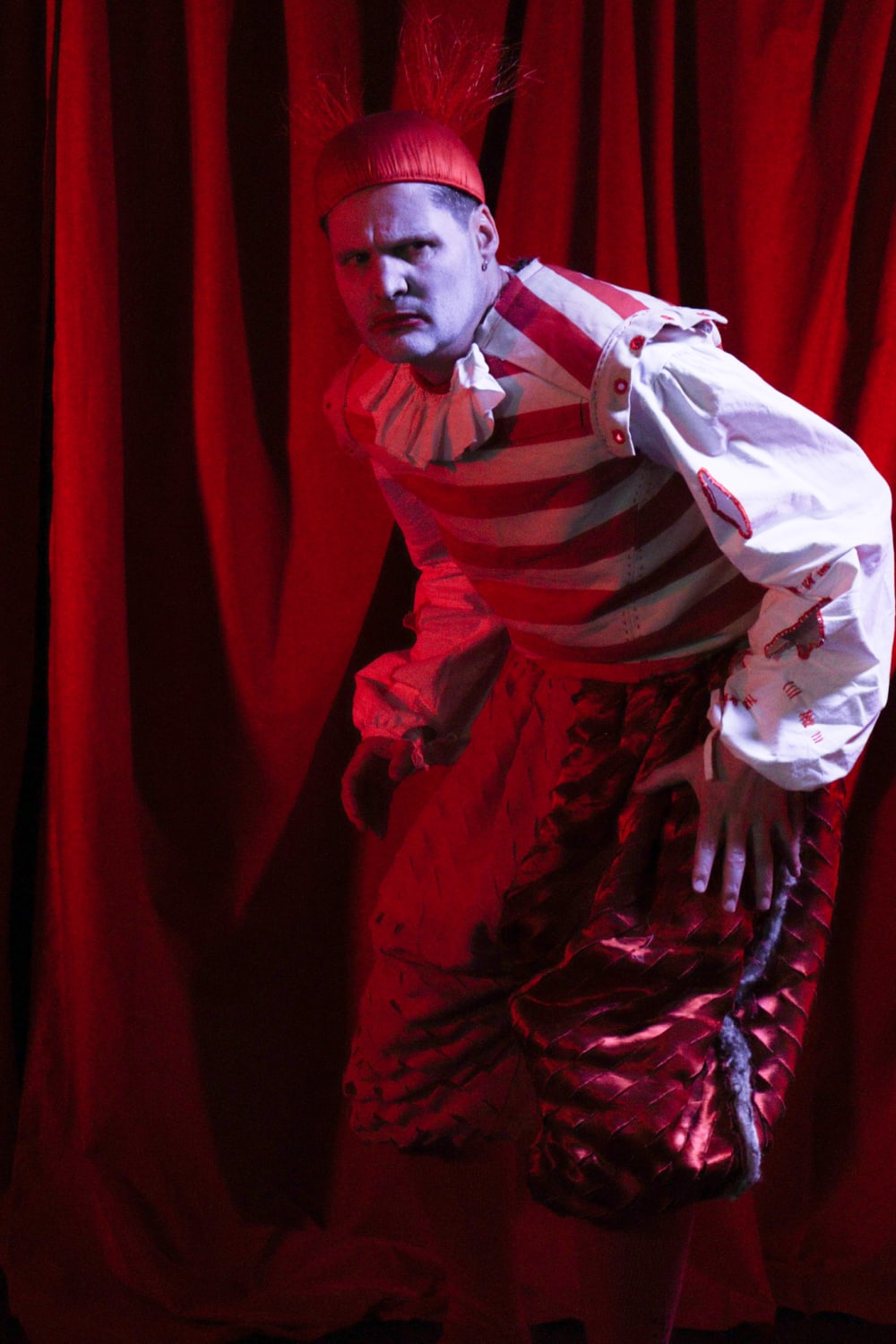 Model wearing red draped costume