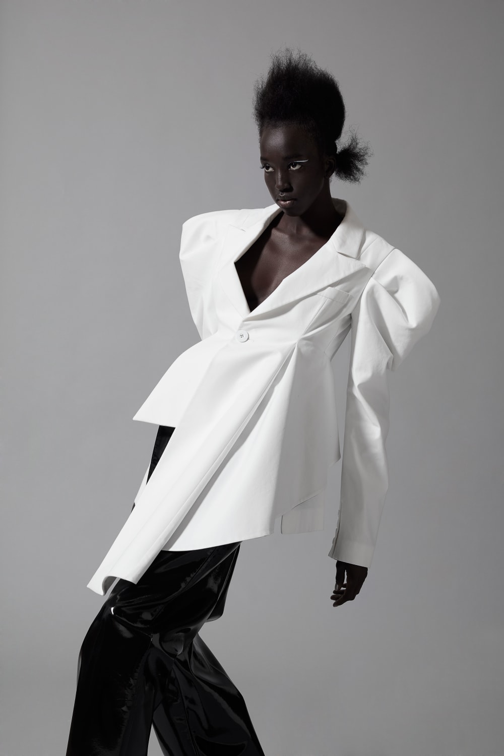 Model in white shirt against grey background