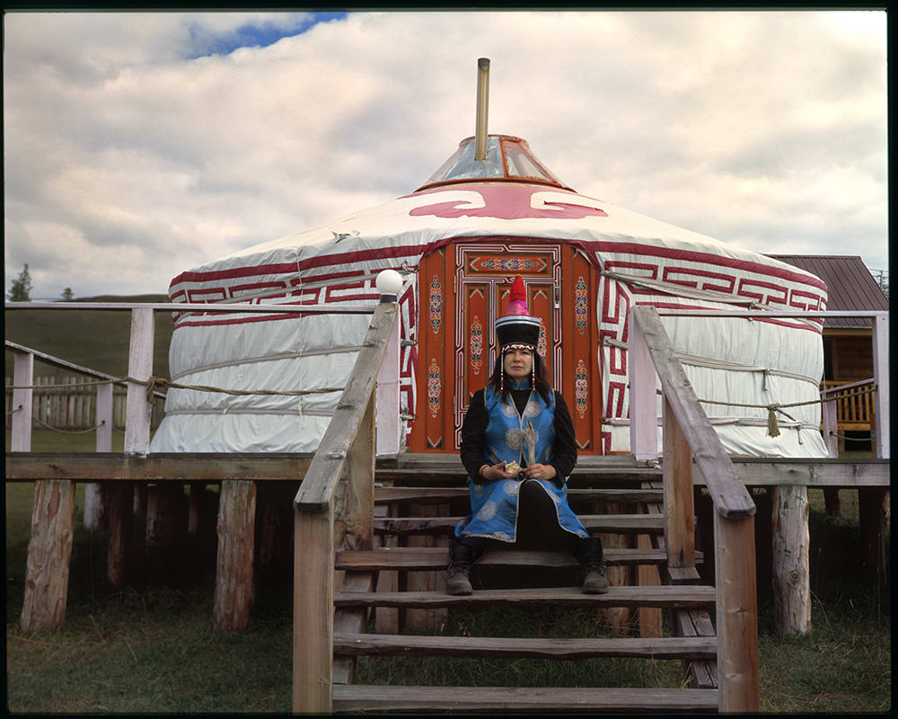 A woman sitting on the steps of a building.